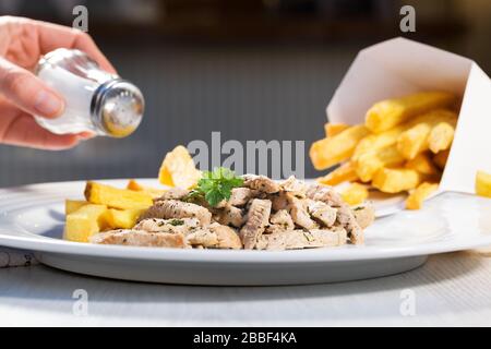 Bifteck rayé avec pesto et pommettes sur la plaque blanche. Cuisine gastronomique de rue. Banque D'Images