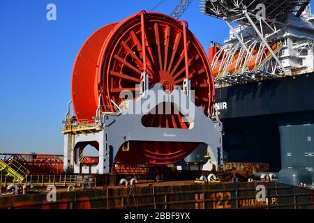 Rotterdam, Pays-Bas-mars 2020: Vue d'une bobine de taille géante dans le cadre d'un système d'entraînement de bobine pour poser le câble dans l'océan; derrière le plus grand navire de grue i Banque D'Images