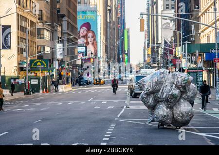 Un collectionneur de CAN marche une septième Avenue vide à New York le jeudi 26 mars 2020. (© Richard B. Levine) Banque D'Images