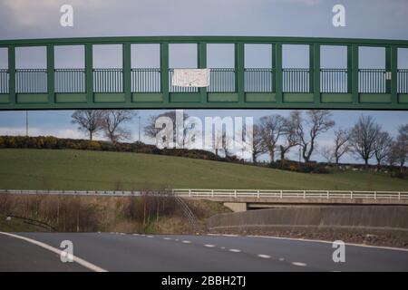 Cumbernauld, Écosse, Royaume-Uni. 31 mars 2020. Photo: Les enfants ont fait un panneau fait maison à l'aide de marqueurs colorés et d'un drap blanc qu'ils ont fixé à un pont piéton sur l'autoroute près de Cumbernauld. Les signes se lisent : « UN GRAND MERCI AUX PRINCIPAUX TRAVAILLEURS QUI SONT EN MESURE DE MAINTENIR la SÉCURITÉ et DE NOURRIR les États-Unis, DE RESTER EN SÉCURITÉ » crédit : Colin Fisher/Alay Live News Banque D'Images