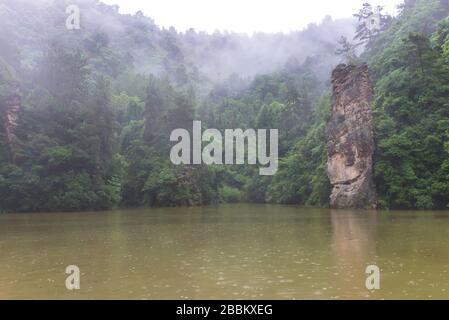 Excursions en bateau sur le lac Baofeng avec forêt luxuriante entourant les hauts sommets de pierre dans la zone panoramique de Wulinguan près de Zhangjiajie, province de Hunan, Chine Banque D'Images