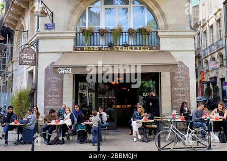 Les gens assis sur des tables sur le café pavé à l'extérieur du Bar des Vedettes aussi connu sous le nom de Bistro chez Fred Banque D'Images