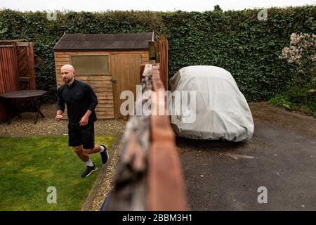 James Campbell, 31 ans, qui est en train de courir un marathon de 26,2 milles dans son jardin à Cheltenham, Gloucestershire tout en étant en verrouillage. Banque D'Images