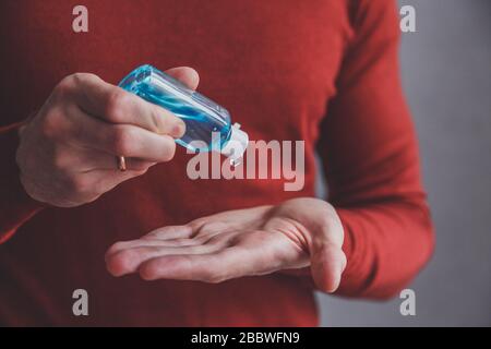 Mains de l'homme utilisant le distributeur de gel désinfectant pour les mains de lavage, coronavirus Covid-19 dans les lieux publics. Concept d'antiseptique, d'hygiène et de soins de santé Banque D'Images