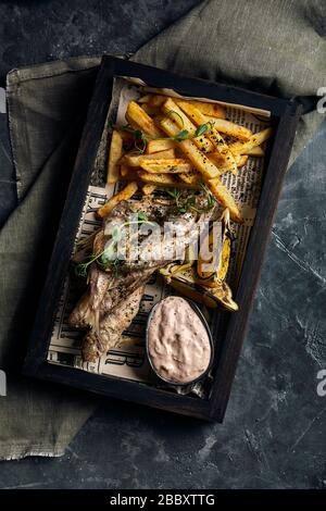 Batumi, Adjara, Géorgie. Plats de la cuisine nationale géorgienne : poisson-mulet rouge frit, citron, sauce Satsivi ou noix, compote de moules et frites. Banque D'Images