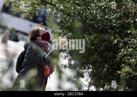 Sofia, Bulgarie - 30 mars 2020: Une femme portant un masque de protection à usage multiple pendant les promenades épidémiques COVID-19 de la maladie de Coronavirus Banque D'Images