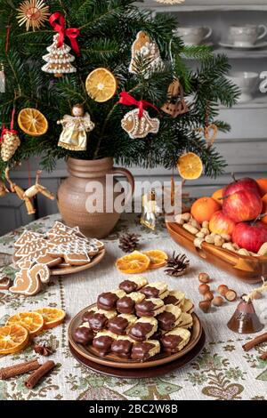 Biscuits de Noël remplis de marmelade et trempés dans du chocolat, disposés sur une plaque Banque D'Images