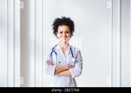 Médecin avec stéthoscope autour de son cou regardant l'appareil photo souriant Banque D'Images