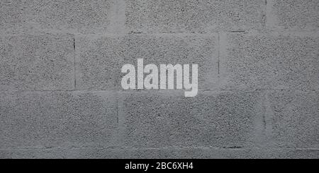 Mur gris en briques de Cinderblock pour la texture de bloc grise d'arrière-plan Banque D'Images