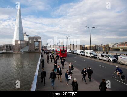 Vue imprenable sur le pont de Londres et la Tamise tandis que les voyageurs traversent le Shard au loin. Banque D'Images