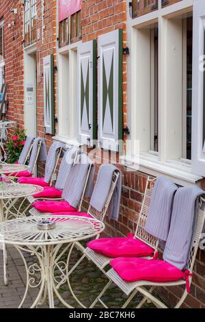 Potsdam, Brandebourg, Allemagne - 12 avril 2018 : sièges confortables dans un café de rue avec coussins magenta colorés Banque D'Images