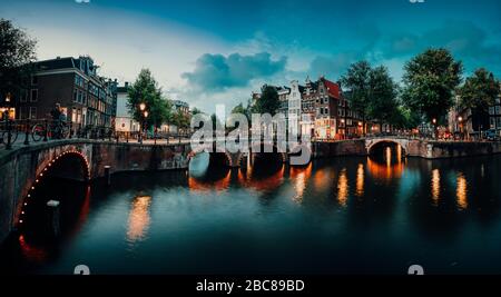 Panorama nocturne sur le paysage urbain d'Amterdam avec canal, pont et maisons médiévales dans l'éclairage du soir. Pont sur Keizersgracht (empereur Banque D'Images