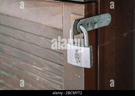 Un cadenas en fer se ferme sur la texture de fond de la porte en bois Banque D'Images
