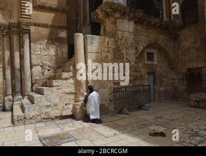 Un chrétien s'agenouille et prie à l'extérieur de l'Église du Saint-Sépulcre, fermée par le coronavirus, le dimanche de Palm, dans la vieille ville de Jérusalem, le dimanche 5 avril 2020. La traditionnelle procession du dimanche de Palm sur le Mt. Des vies ont été annulées en raison de l'éclosion de COVID-19, car les chrétiens palestiniens sont isolés et les touristes ont annulé des visites en Terre Sainte. Photo de Debbie Hill/UPI Banque D'Images