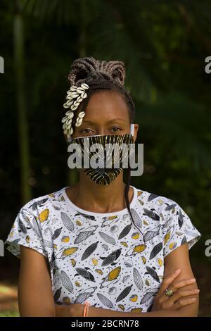 Une femme kenyane portant un masque fait maison à partir d'un tissu Kanga traditionnel pour la protection contre la pandémie de covid-19. Les masques chirurgicaux sont en sup court Banque D'Images