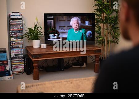 Les gens de Wandsworth, Londres, regardent la reine Elizabeth II livrer son allocution à la nation et au Commonwealth en relation avec l'épidémie de coronavirus. Banque D'Images