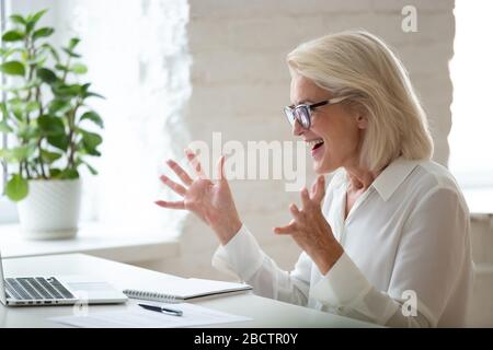 Une femme d'affaires de 60 ans a été enthousiasmée pour célébrer la réussite des entreprises. Banque D'Images