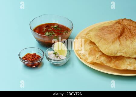 Plat indien épicé Chick Peas curry aussi connu sous le nom de Chole Bhatura et Chana Masala, déjeuner traditionnel du nord de l'inde servi avec des puri frits ou des pains plats Banque D'Images