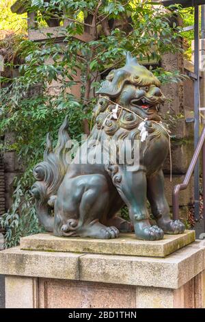 tokyo, japon - 05 mars 2020: Statue de bronze d'un lion komainu gardien mythologique avec corde shimenawa sur le cou dans le temple japonais ATAGO de Tokyo. Banque D'Images