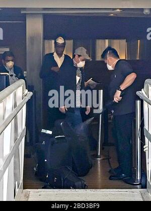 Les passagers et les membres d'équipage qui débarquent du navire de croisière Celebrity Eclipse sont vaporisés de désinfectant au port de San Diego le 5 avril 2020 à San Diego, en Californie. Plus de deux mille passagers ont été blindés puis autorisés à partir dans les autobus et les avions pour rentrer à la maison. Banque D'Images