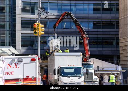 New York, États-Unis. 06 avril 2020. Au milieu d'un sommet prévu dans les décès de COVID-19, les travailleurs de la construction construisent une structure réfrigérée dans le parking ambulancier du NYU Langone Medical Center à New York, NY, États-Unis, le lundi 6 avril 2020. (Photo d'Albin Lohr-Jones/Sipa USA) crédit: SIPA USA/Alay Live News Banque D'Images