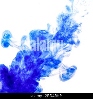 Encre bleue injectée dans l'eau à partir de la seringue, mélange de couleurs avec de l'eau créant des formes abstraites, Banque D'Images