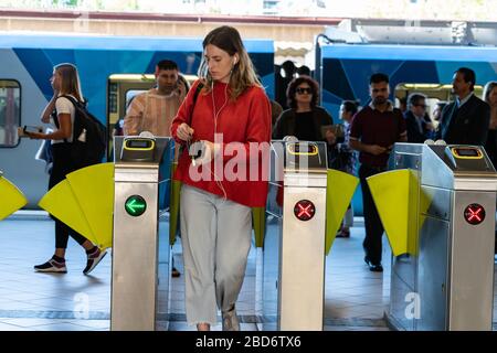 Melbourne Australie - 10 mars 2020; gare de voyageurs urbains avec une femme passant par la porte et les passagers arrivant. Banque D'Images