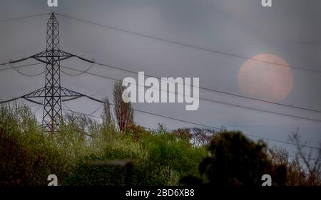 Wimbledon, Londres, Royaume-Uni. 7 avril 2020. La Super Lune, ou Lune rose, s'élève au-dessus des banlieues de Londres dans le ciel nocturne brumeux, atteignant la pleine lune à 03.35. Crédit : Malcolm Park/Alay Live News Banque D'Images