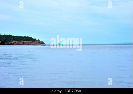 Un bateau de pêche au homard quittant le port et se dirigeant vers l'eau libre depuis le quai de Saint Martins Nouveau-Brunswick Canada. Banque D'Images