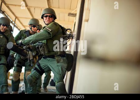 Groupe d'agents de police sur le point d'entrer dans un bâtiment au cours d'un exercice à un centre de formation. Banque D'Images