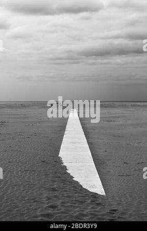 Perspective du chemin sur la plage de sable - paysage minimaliste, photographie noir et blanc Banque D'Images