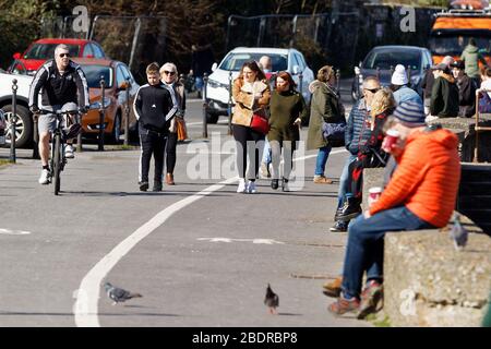 Photo : les gens profitent du soleil au bord de la mer à Mumbles près de Swansea, Pays de Galles, Royaume-Uni. Dimanche 22 mars 2020 Re: Covid-19 pandémie de coronavirus, Royaume-Uni. Banque D'Images