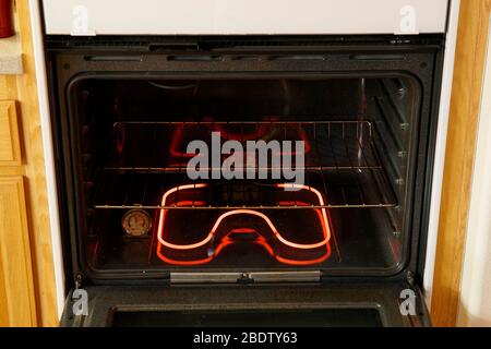 À l'intérieur d'un four électrique à convection montrant excité serpentins de chauffage, four, feux de cuisson et étagère. Banque D'Images