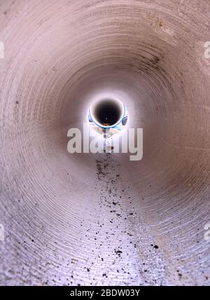 En regardant à l'intérieur du tuyau HDPE de grand diamètre pour l'approvisionnement en eau potable. Réparation du système de distribution d'eau en ville Banque D'Images