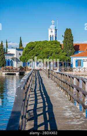 Le beau monastère de Saint-Nicolas construit sur le lac de Vistonida, Porto Lagos, région de Xanthi dans le nord de la Grèce, vue avec le pont d'eau Banque D'Images