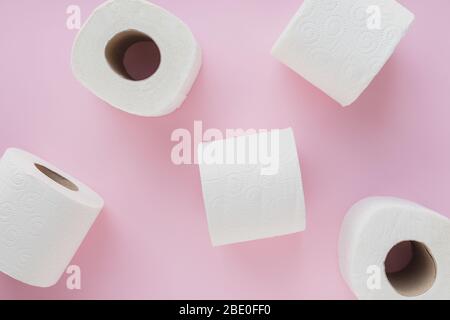 Vue de dessus des rouleaux de papier toilette, sur fond rose clair pastel. Scène minimale d'épidémie de virus corona. Pénurie, panique. Banque D'Images