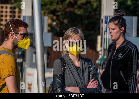 Londres, Royaume-Uni. 11 avril 2020. Un couple de masques assortis se dirige vers les mini Sainsburys de la station-service - le 'verrouillage' continue pour l'épidémie de Coronavirus (Covid 19) à Londres. Crédit: Guy Bell/Alay Live News Banque D'Images