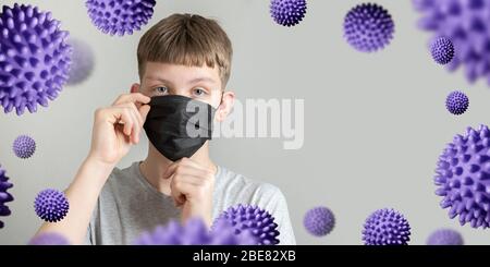 L'adolescent met sur le masque noir protecteur contre le coronavirus et les bactéries. Espace pour le texte. Prévention de Covid 19. Quarantaine. Banque D'Images