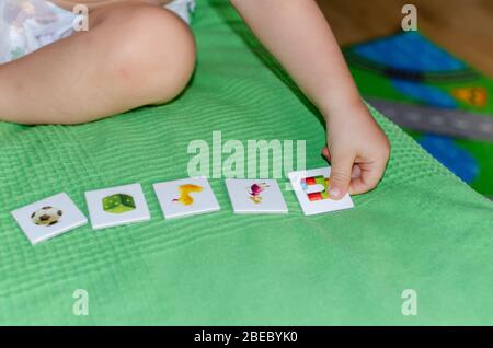 Enfant portant des jouets sur le sol à la maison. Concept d'éducation des enfants. Banque D'Images