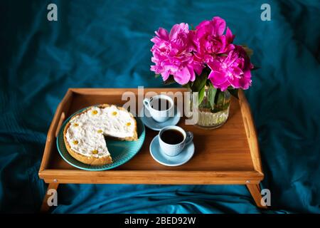 Beau matin cheesecake vanille, café, tasses bleu, rose de pivoines dans un vase en verre Banque D'Images