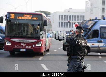 Rome, Italie. 13 avril 2020. Les policiers arrêtent un bus pour s'enregistrer à Rome, en Italie, le 13 avril 2020. La pandémie COVID-19 a fait état de 20 465 morts en Italie à la suite de la période de lundi, portant le nombre total d'infections, de morts et de reprises à 159 516, selon les dernières données publiées par le Département de la protection civile du pays. Crédit: Augusto Casasoli/Xinhua/Alay Live News Banque D'Images