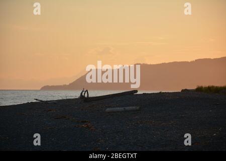 Vue sur le coucher du soleil depuis la plage du camping Homer Spit en face de la baie de Kachemak, en Alaska, aux États-Unis Banque D'Images