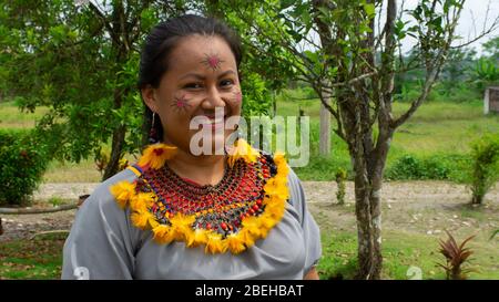 Femme du groupe ethnique Cofan souriant dans des vêtements traditionnels de la communauté du millénaire Cofan Dureno située au bord de la rivière Aguarico Banque D'Images