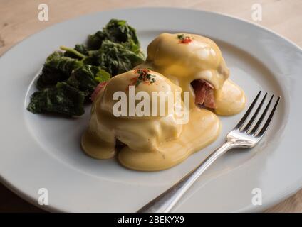 Œufs Benoît avec du jambon maison et des feuilles d'hogweed fourrés, servi pour le petit déjeuner au Lion rouge à Stodmarsh, dans le sud-est du Kent Banque D'Images