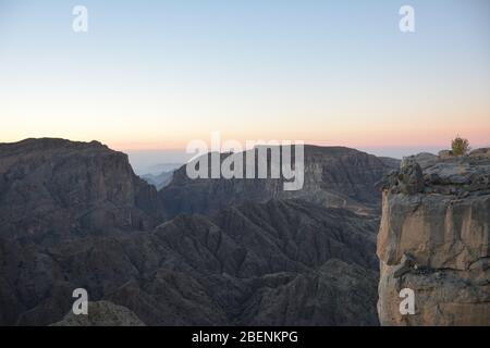 Vue sur le coucher du soleil du 'Grand Canyon d'Arabie', ou les Jbel Shams, dans les montagnes Hajar d'Oman Banque D'Images