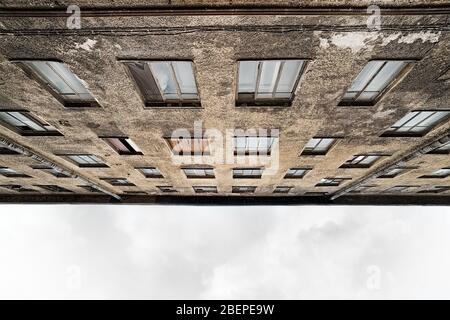 Ancienne vue de bas angle du bâtiment abandonné. Résidentiel déserté avec des fenêtres partiellement cassées Banque D'Images
