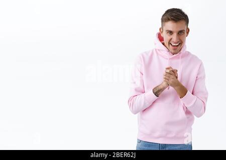 Portrait de l'homme blond enthousiaste prêt à l'action, les mains battes ensemble, frottant les paumes comme bon affaire, décrire l'événement incroyable ou Banque D'Images