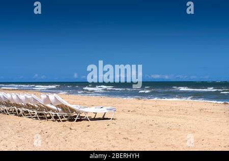 Chaises longues vides sur une plage ensoleillée à Porto Rico Banque D'Images