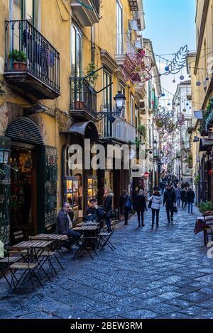 Les gens qui se promenent dans une rue typique de la vieille ville de Salerne pendant les vacances de Noël. Salerne, Campanie, Italie, décembre 2019 Banque D'Images