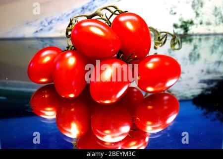 Les tomates rouges mûres sont tournées dans des couleurs vives en gros plan et nettes. Avec une réflexion, avec et sans gouttelettes d'eau Banque D'Images